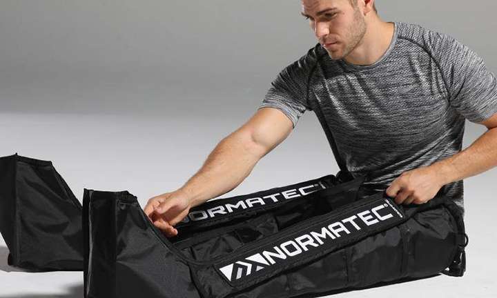 Man using Normatec recovery system.